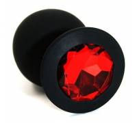 Чёрная силиконовая анальная пробка с красным кристаллом - 7 см.